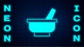Glowing neon Mortar and pestle icon isolated on brick wall background. Vector Royalty Free Stock Photo
