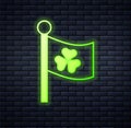 Glowing neon National Ireland flag with clover trefoil leaf icon isolated on brick wall background. Happy Saint Patricks