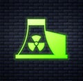 Glowing neon Nuclear power plant icon isolated on brick wall background. Energy industrial concept. Vector
