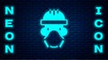 Glowing neon Nuclear power plant worker wearing protective clothing icon isolated on brick wall background. Nuclear