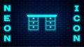 Glowing neon Office desk icon isolated on brick wall background. Vector