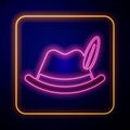 Glowing neon Oktoberfest hat icon isolated on black background. Hunter hat with feather. German hat. Vector