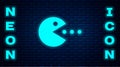Glowing neon Pacman with eat icon isolated on brick wall background. Arcade game icon. Pac man sign. Vector