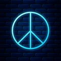 Glowing neon Peace sign icon isolated on brick wall background. Hippie symbol of peace. Vector