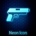 Glowing neon Pistol or gun icon isolated on brick wall background. Police or military handgun. Small firearm. Vector