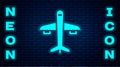 Glowing neon Plane icon isolated on brick wall background. Flying airplane icon. Airliner sign. Vector Royalty Free Stock Photo