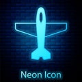 Glowing neon Plane icon isolated on brick wall background. Flying airplane icon. Airliner sign. Vector Royalty Free Stock Photo