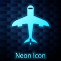 Glowing neon Plane icon isolated on brick wall background. Flying airplane icon. Airliner sign. Vector Royalty Free Stock Photo