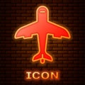 Glowing neon Plane icon isolated on brick wall background. Flying airplane icon. Airliner sign. Vector Royalty Free Stock Photo