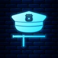 Glowing neon Police cap and rubber baton icon isolated on brick wall background. Security truncheons. Police stick