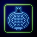 Glowing neon Pomegranate icon isolated on blue background. Garnet fruit. Vector