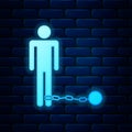 Glowing neon Prisoner with ball on chain icon isolated on brick wall background