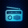 Glowing neon Radio with antenna icon isolated on brick wall background. Vector Royalty Free Stock Photo