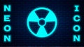Glowing neon Radioactive icon isolated on brick wall background. Radioactive toxic symbol. Radiation Hazard sign. Vector Royalty Free Stock Photo