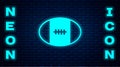 Glowing neon Rugby ball icon isolated on brick wall background. Vector