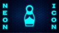 Glowing neon Russian doll matryoshka icon isolated on brick wall background. Vector