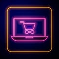 Glowing neon Shopping cart on screen laptop icon isolated on black background. Concept e-commerce, e-business, online Royalty Free Stock Photo