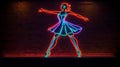 Glowing Neon Sign Against a Dark Wall Featuring a Dancing Couple