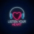 Glowing neon sign with headphones, heart shape and listen your heart slogan. Call to listen symbol with inscription Royalty Free Stock Photo