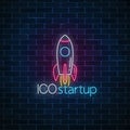 Glowing neon sign of ICO project startup. Business fast start symbol as a flying rocket in neon style