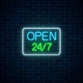 Glowing neon sign of open 24 hours 7 days a week store in geometric shape on a brick wall background. Royalty Free Stock Photo