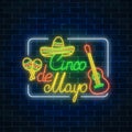 Glowing neon sinco de mayo holiday sign in rectangle frame on dark brick wall background. Mexican festival flyer. Royalty Free Stock Photo