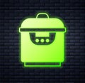Glowing neon Slow cooker icon isolated on brick wall background. Electric pan. Vector