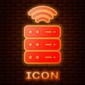 Glowing neon Smart Server, Data, Web Hosting icon isolated on brick wall background. Internet of things concept with Royalty Free Stock Photo