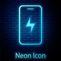 Glowing neon Smartphone charging battery icon isolated on brick wall background. Phone with a low battery charge. Vector Royalty Free Stock Photo
