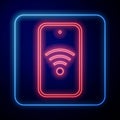 Glowing neon Smartphone with free wi-fi wireless connection icon isolated on blue background. Wireless technology, wi-fi Royalty Free Stock Photo