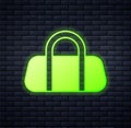 Glowing neon Sport bag icon isolated on brick wall background. Vector