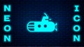 Glowing neon Submarine icon isolated on brick wall background. Military ship. Vector