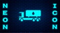 Glowing neon Tanker truck icon isolated on brick wall background. Petroleum tanker, petrol truck, cistern, oil trailer