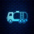 Glowing neon Tanker truck icon isolated on brick wall background. Petroleum tanker, petrol truck, cistern, oil trailer