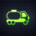 Glowing neon Tanker truck icon isolated on brick wall background. Petroleum tanker, petrol truck, cistern, oil trailer