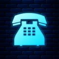 Glowing neon Telephone icon isolated on brick wall background. Landline phone. Vector Royalty Free Stock Photo