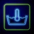 Glowing neon Temperature wash icon isolated on blue background. Temperature wash. Vector