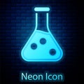 Glowing neon Test tube and flask chemical laboratory test icon isolated on brick wall background. Laboratory glassware