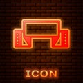 Glowing neon Traditional Ukrainian embroidered towel icon isolated on brick wall background. Vector