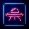 Glowing neon UFO flying spaceship icon isolated on blue background. Flying saucer. Alien space ship. Futuristic unknown Royalty Free Stock Photo