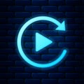 Glowing neon Video play button like simple replay icon isolated on brick wall background. Vector