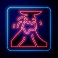 Glowing neon Volcano eruption with lava icon isolated on black background. Vector