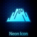 Glowing neon Volcano eruption with lava icon isolated on brick wall background. Vector