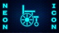 Glowing neon Wheelchair for disabled person icon isolated on brick wall background. Vector Royalty Free Stock Photo