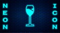 Glowing neon Wine glass icon isolated on brick wall background. Wineglass icon. Goblet symbol. Glassware sign. Happy Royalty Free Stock Photo