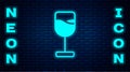 Glowing neon Wine glass icon isolated on brick wall background. Wineglass icon. Goblet symbol. Glassware sign. Happy Royalty Free Stock Photo