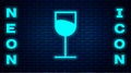 Glowing neon Wine glass icon isolated on brick wall background. Wineglass sign. Vector Illustration Royalty Free Stock Photo