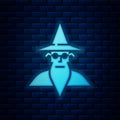 Glowing neon Wizard warlock icon isolated on brick wall background