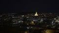 Glowing night city with bright old cathedral. Action. Beautiful view of night city with glowing cathedral. Panorama of Royalty Free Stock Photo