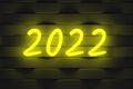 Glowing numbers 2022 on dark wall. Neon effect. Annual planning. New Year`s and Christmas